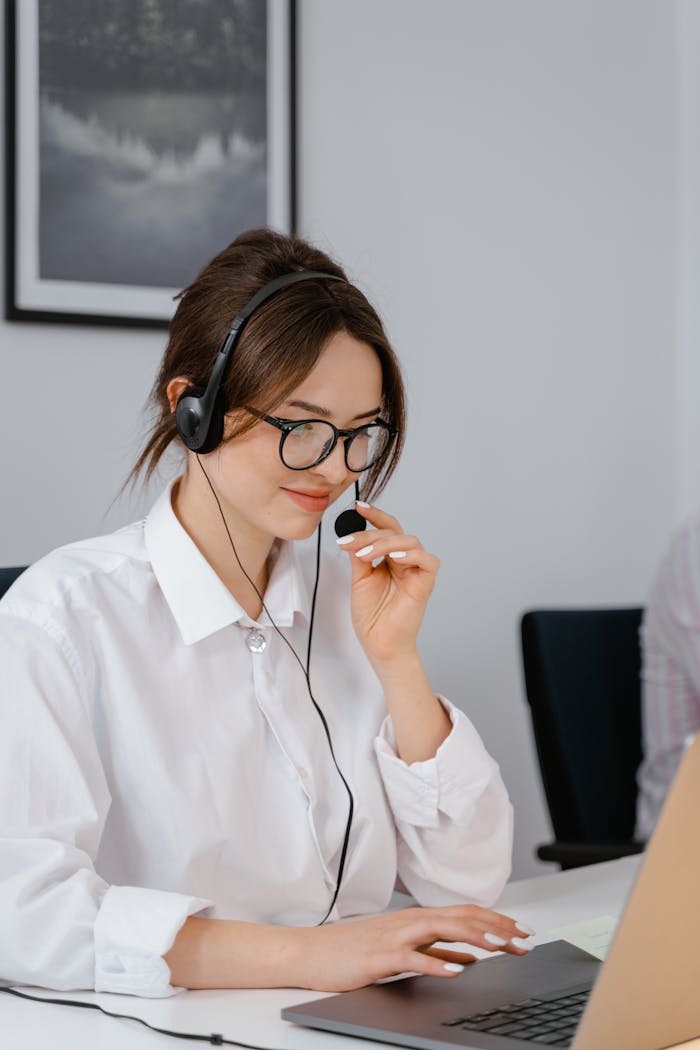 Mastering the First Impression: Your intriguing post title goes here Professional woman using headset for customer service in office setting.